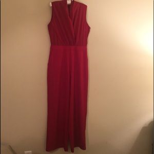 Red jumpsuit with gold zipper.